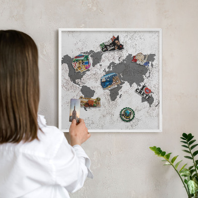 Magnetic board for travel magnets in a white frame World map