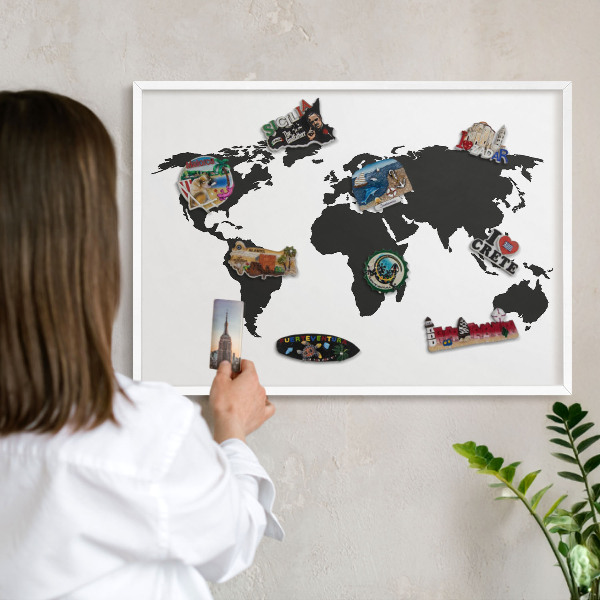Magnetic board for travel magnets in a white frame World map