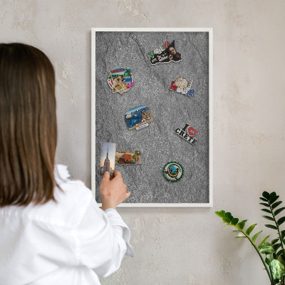 Magnetic board for travel magnets in a white frame Gray stone