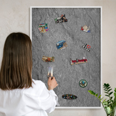 Magnetic board for travel magnets in a white frame Gray stone