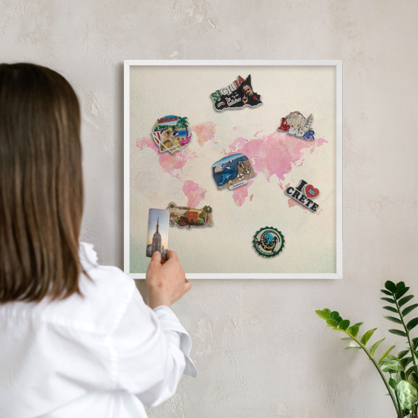 Magnetic board for travel magnets in a white frame World map