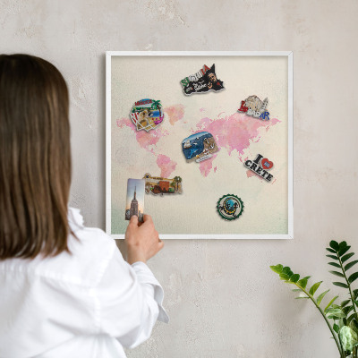 Magnetic board for travel magnets in a white frame World map