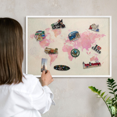Magnetic board for travel magnets in a white frame World map