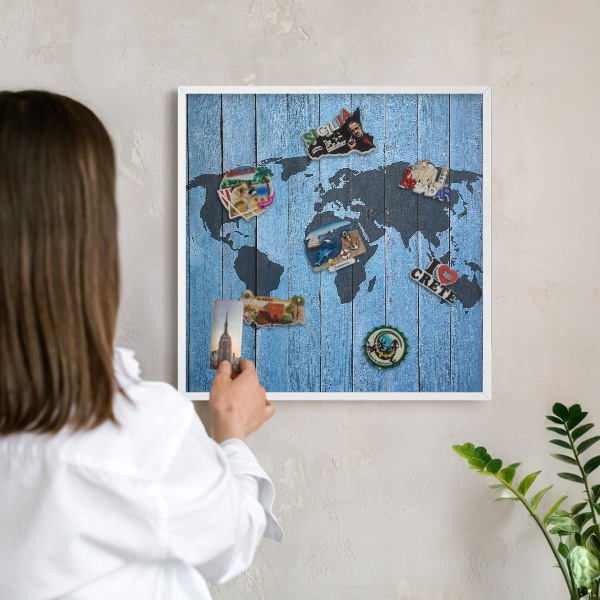 Magnetic board for travel magnets in a white frame World map