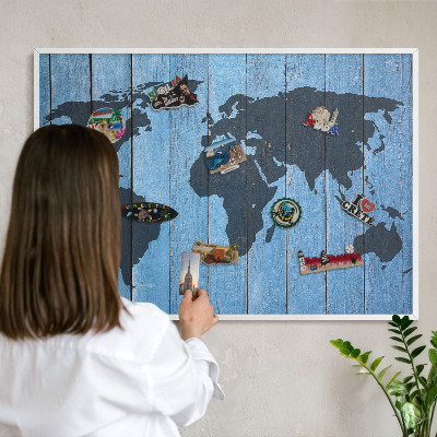 Magnetic board for travel magnets in a white frame World map