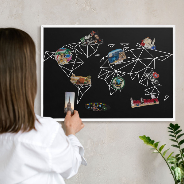 Magnetic board for travel magnets in a white frame World map