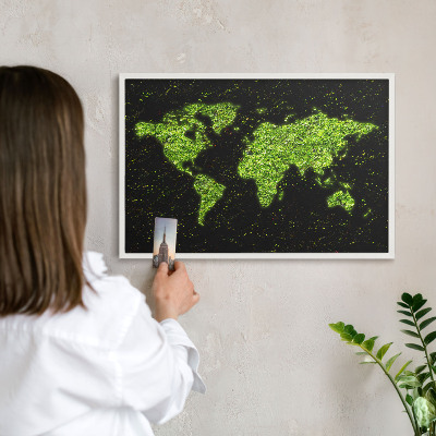 Magnetic board for travel magnets in a white frame Green map