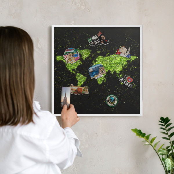 Magnetic board for travel magnets in a white frame Green map