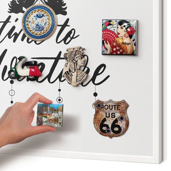 Magnetic board for travel magnets in a white frame Adventure awaits