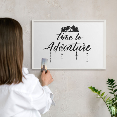 Magnetic board for travel magnets in a white frame Adventure awaits