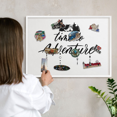 Magnetic board for travel magnets in a white frame Adventure awaits
