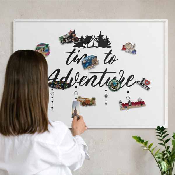 Magnetic board for travel magnets in a white frame Adventure awaits