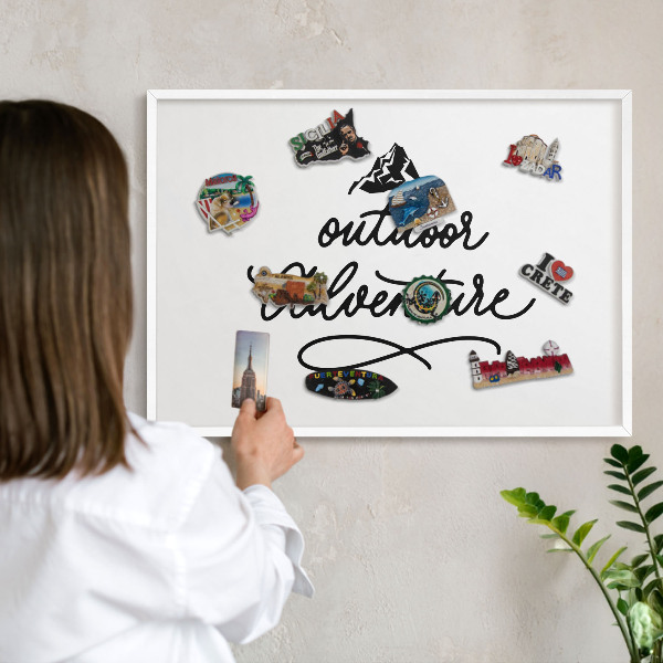Magnetic board for travel magnets in a white frame Mountain adventure