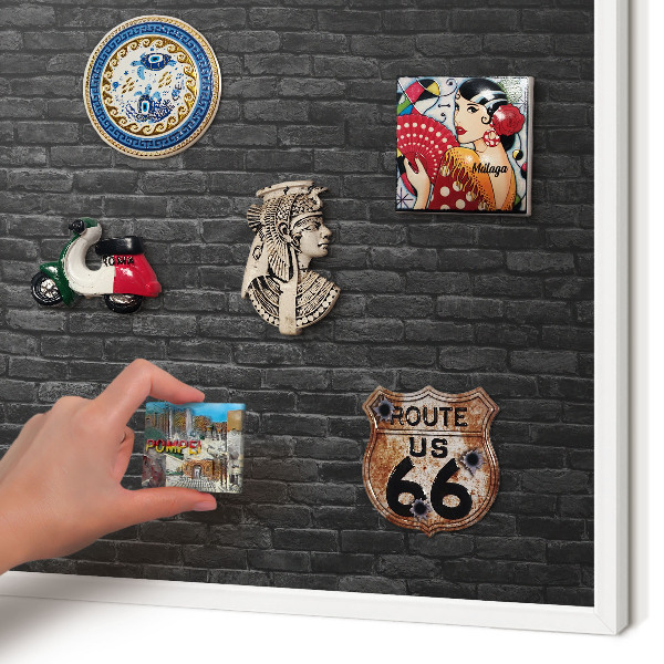 Magnetic board for travel magnets in a white frame Brick wall