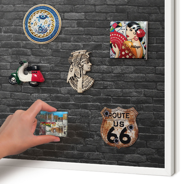 Magnetic board for travel magnets in a white frame Brick wall