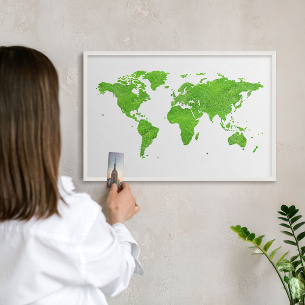 Magnetic board for travel magnets in a white frame Green map
