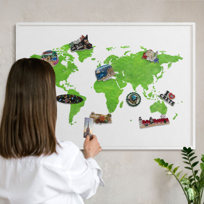 Magnetic board for travel magnets in a white frame Green map