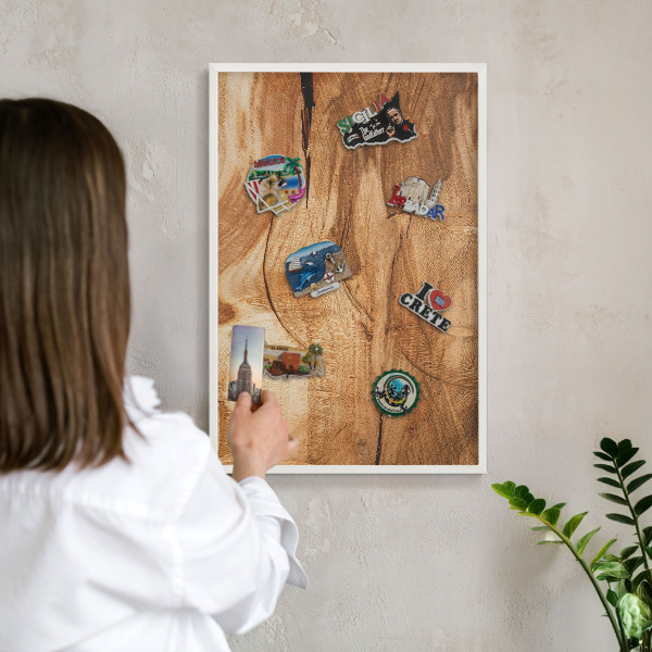 Magnetic board for travel magnets in a white frame Natural wood
