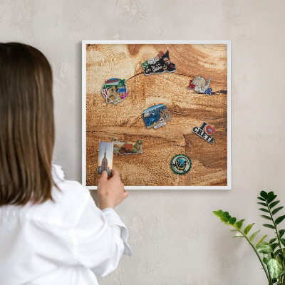 Magnetic board for travel magnets in a white frame Natural wood