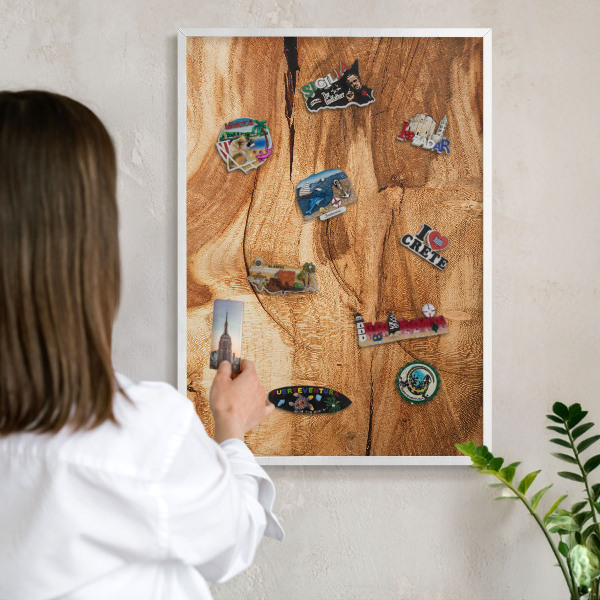 Magnetic board for travel magnets in a white frame Natural wood