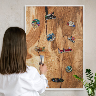 Magnetic board for travel magnets in a white frame Natural wood