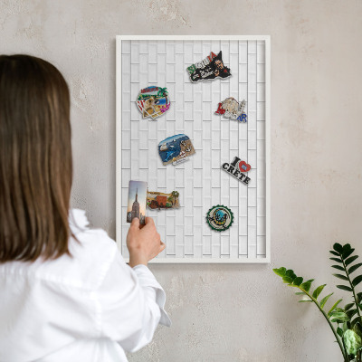 Magnetic board for travel magnets in a white frame White bricks