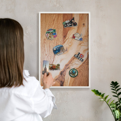 Magnetic board for travel magnets in a white frame Wooden texture