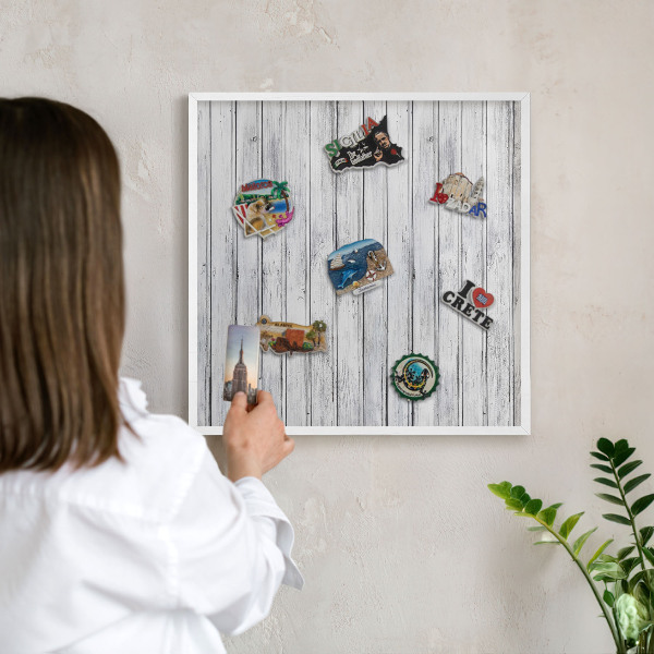 Magnetic board for travel magnets in a white frame Light wood