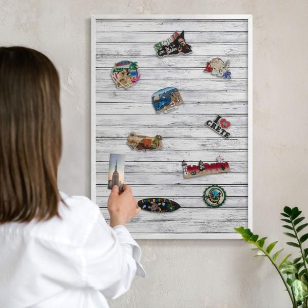 Magnetic board for travel magnets in a white frame Light wood