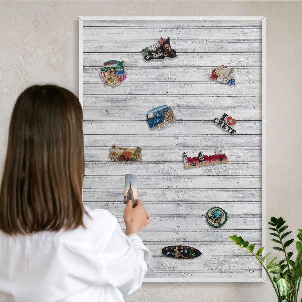 Magnetic board for travel magnets in a white frame Light wood