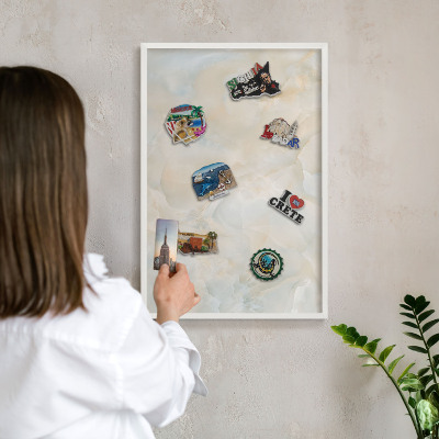 Magnetic board for travel magnets in a white frame Subtle elegance