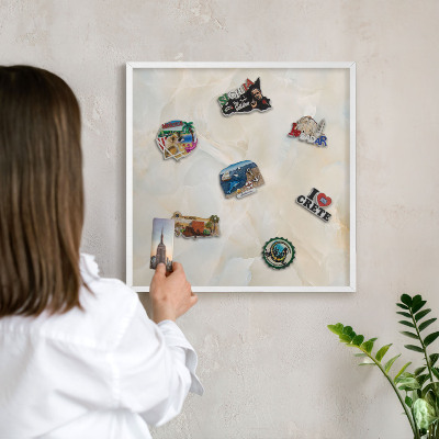 Magnetic board for travel magnets in a white frame Subtle elegance