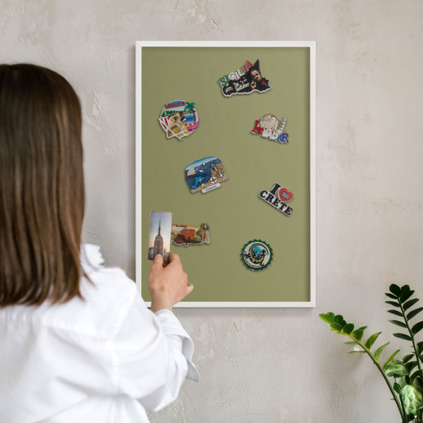 Magnetic board for travel magnets in a white frame Green grass