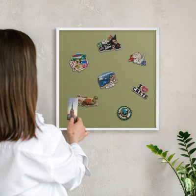 Magnetic board for travel magnets in a white frame Green grass