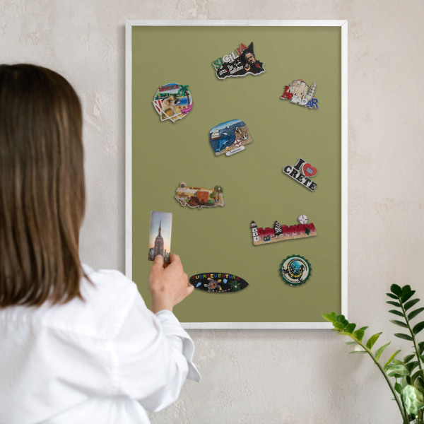 Magnetic board for travel magnets in a white frame Green grass