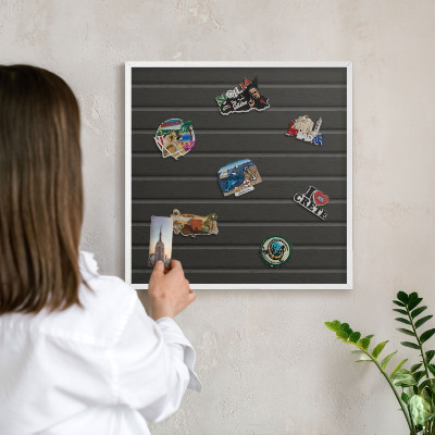 Magnetic board for travel magnets in a white frame Panel texture