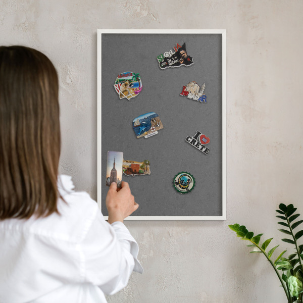 Magnetic board for travel magnets in a white frame Gray texture