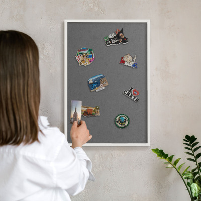 Magnetic board for travel magnets in a white frame Gray texture