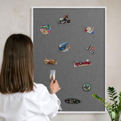 Magnetic board for travel magnets in a white frame Gray texture