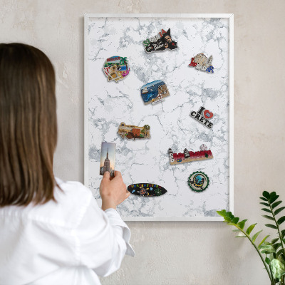 Magnetic board for travel magnets in a white frame Marble aesthetics