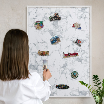 Magnetic board for travel magnets in a white frame Marble aesthetics