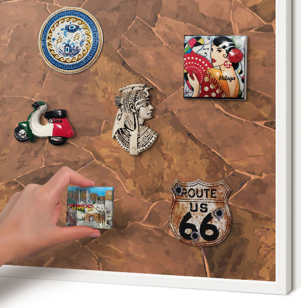 Magnetic board for travel magnets in a white frame Stone structure