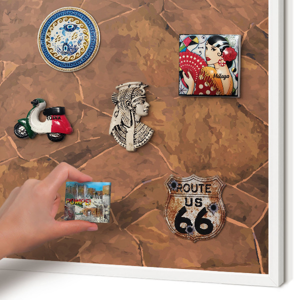 Magnetic board for travel magnets in a white frame Stone structure