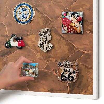 Magnetic board for travel magnets in a white frame Stone structure