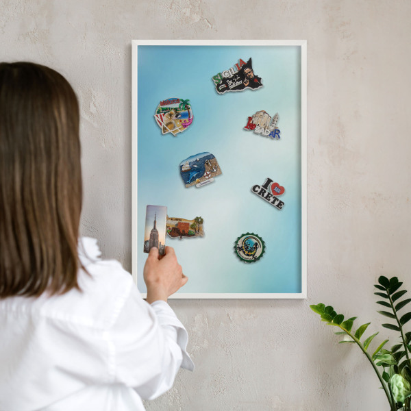 Magnetic board for travel magnets in a white frame Blue sky