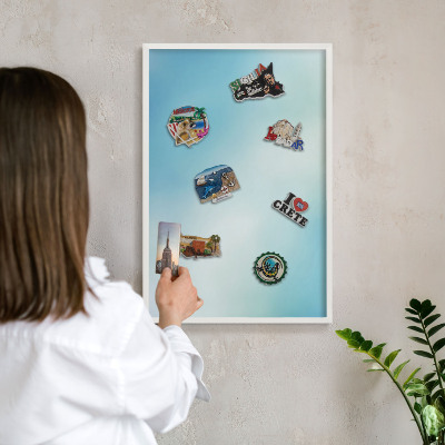 Magnetic board for travel magnets in a white frame Blue sky