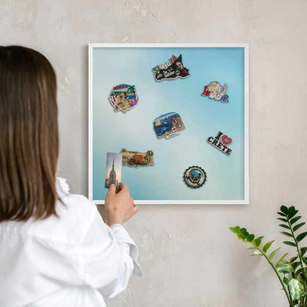 Magnetic board for travel magnets in a white frame Blue sky