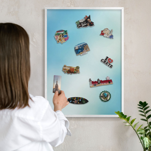 Magnetic board for travel magnets in a white frame Blue sky