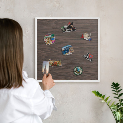 Magnetic board for travel magnets in a white frame Natural wood
