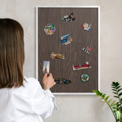 Magnetic board for travel magnets in a white frame Natural wood